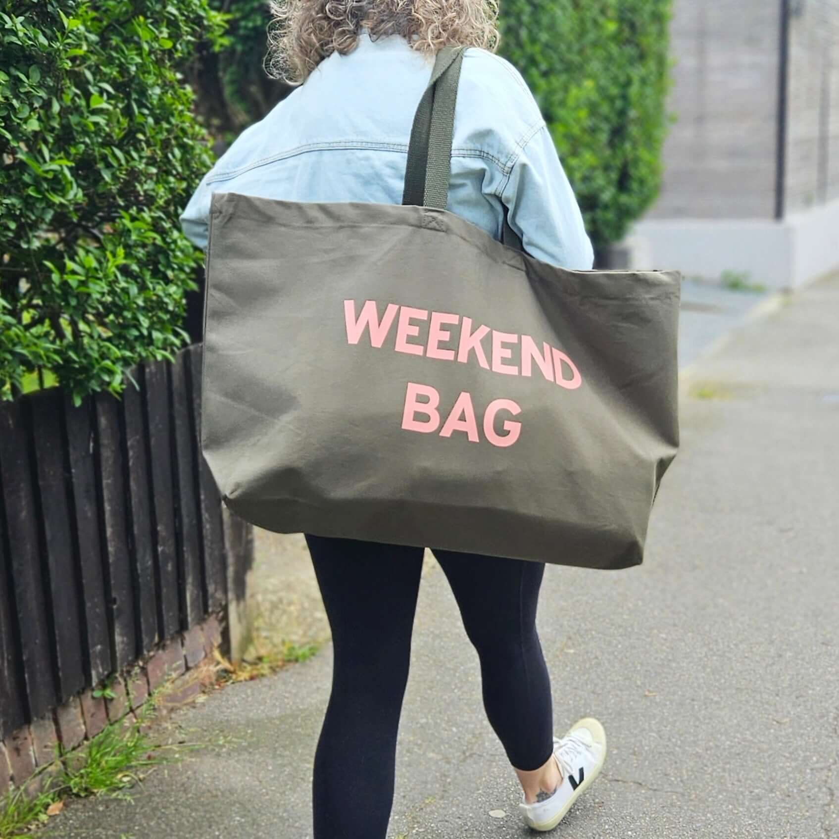oversized olive green tote bag with a pale pink text 'Weekend Bag'