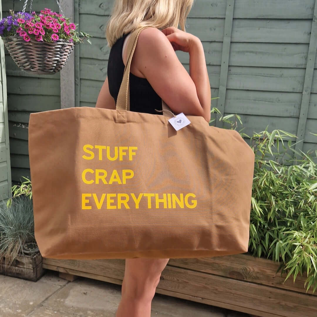 Brown oversized tote bag with a yellow text 'stuff crap everything'
