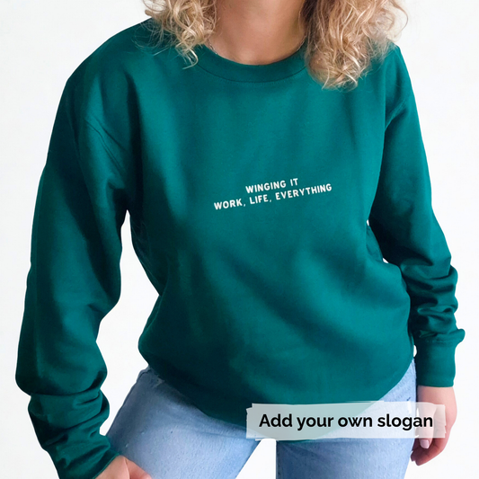 Green sweatshirt with text 'Winging it, Work, Life, Everything' on a white background