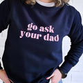 Mum wearing a cosy sweatshirt, holding a coffee cup