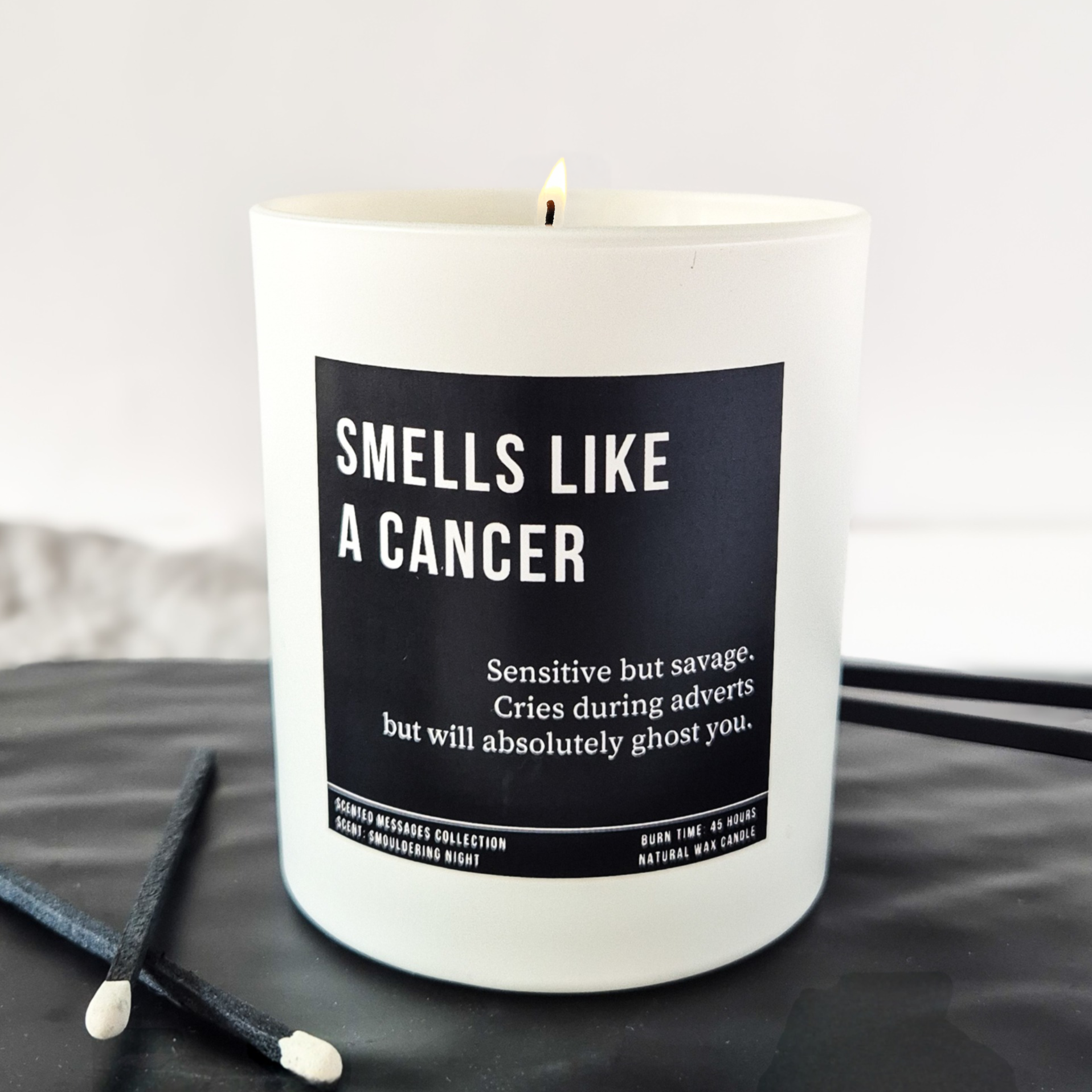 white candle with black label and custom text. Zodiac candle