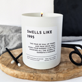 a white candle with personalised year and custom message on a wooden tray