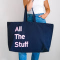 Large navy personalised tote bag with pink bold text reading All The Stuff, carry ion the shoulder