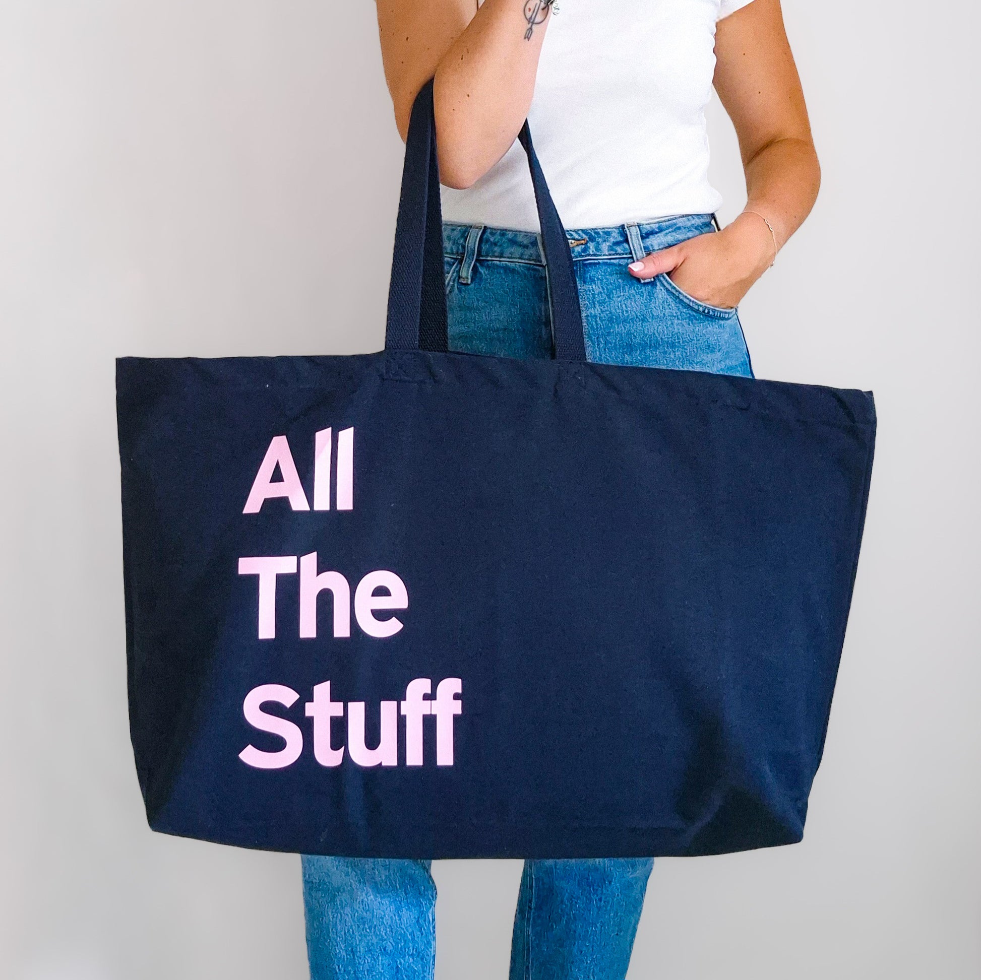 Large navy personalised tote bag with pink bold text reading All The Stuff, carry ion the shoulder