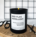 Black candle with bold white label reading Red Flag Repellent, funny breakup gift