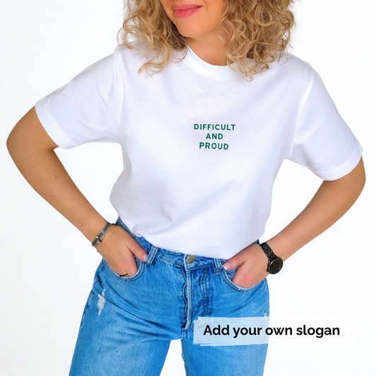 Person wearing a white t-shirt with text 'Difficult and proud' and blue jeans on a white background