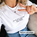 Person wearing a white t-shirt with text 'Got my shit together just kidding pure chaos'  and making a peace sign.
