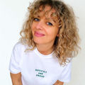 Woman wearing a white t-shirt with 'DIFFICULT AND PROUD' text on a plain background
