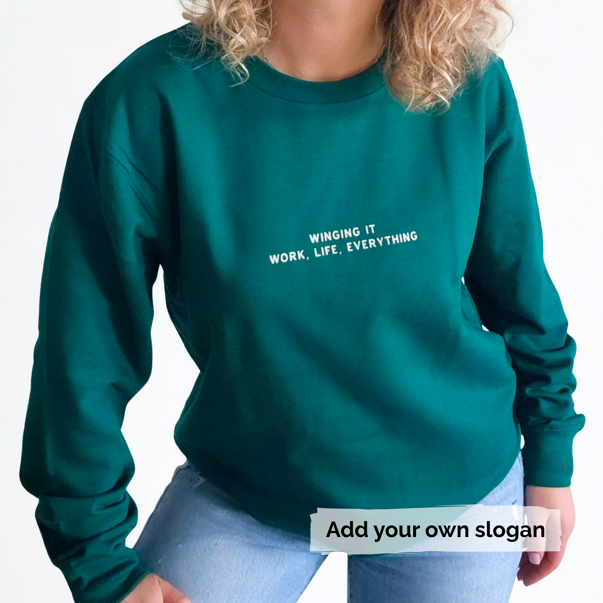 Green sweatshirt with text 'Winging it, Work, Life, Everything' on a white background